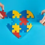 Pezzi di puzzle di vari colori che formano un cuore